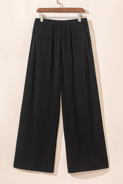 Pantalones anchos elegantes con pliegues negros