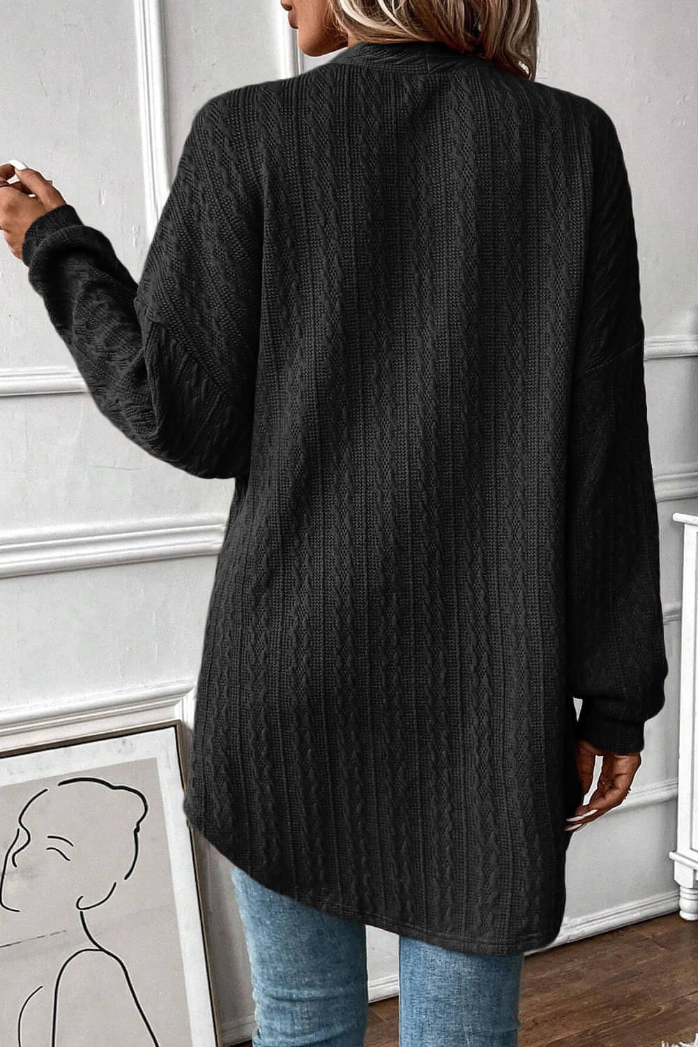 Cardigan noir ouvert sur le devant avec poches latérales en tricot texturé