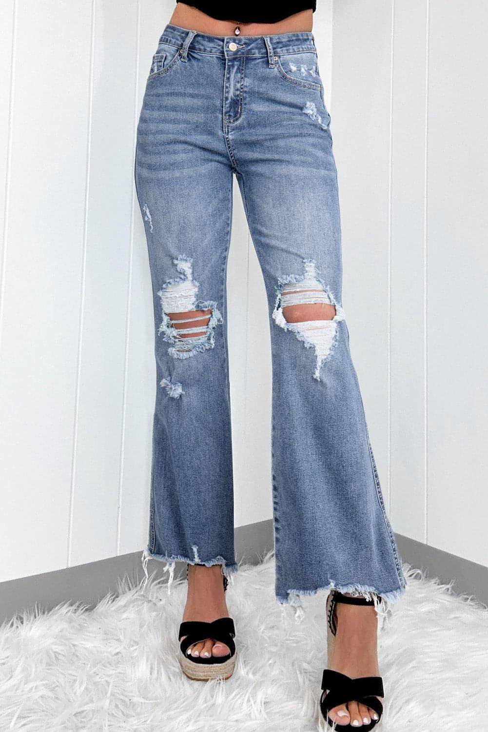 Dunkelblaue, hoch sitzende, zerrissene, ausgestellte Jeans mit Distressed-Saum