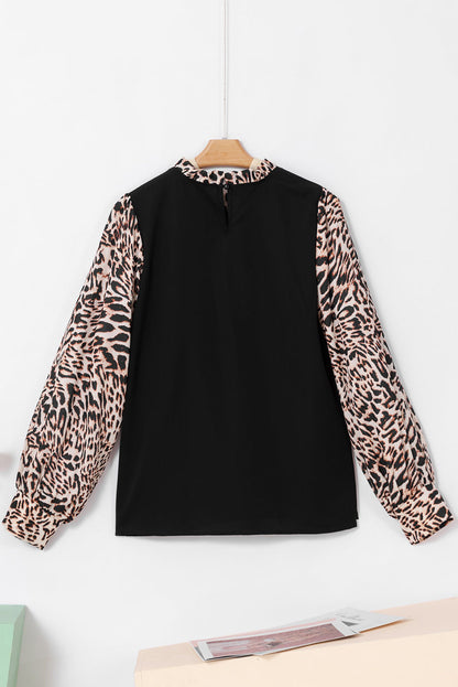 Schwarze Bluse mit Laternenärmeln und kontrastierendem Leopardenmuster