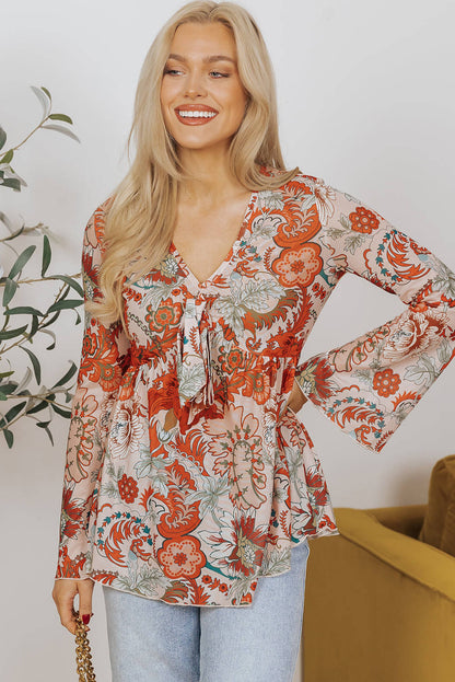 Blusa con escote en V profundo, mangas acampanadas y nudo y estampado floral naranja