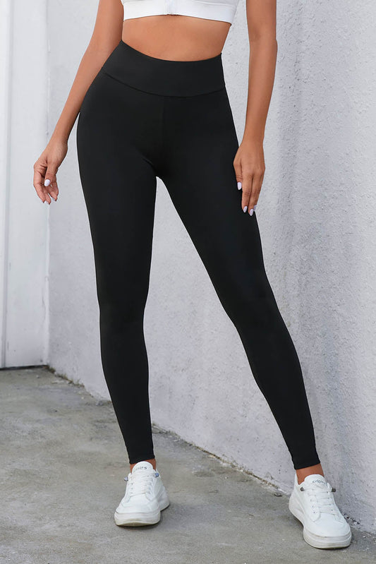 Leggings negros de cintura alta con control de abdomen y diseño entrecruzado