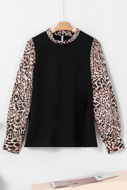 Schwarze Bluse mit Laternenärmeln und kontrastierendem Leopardenmuster